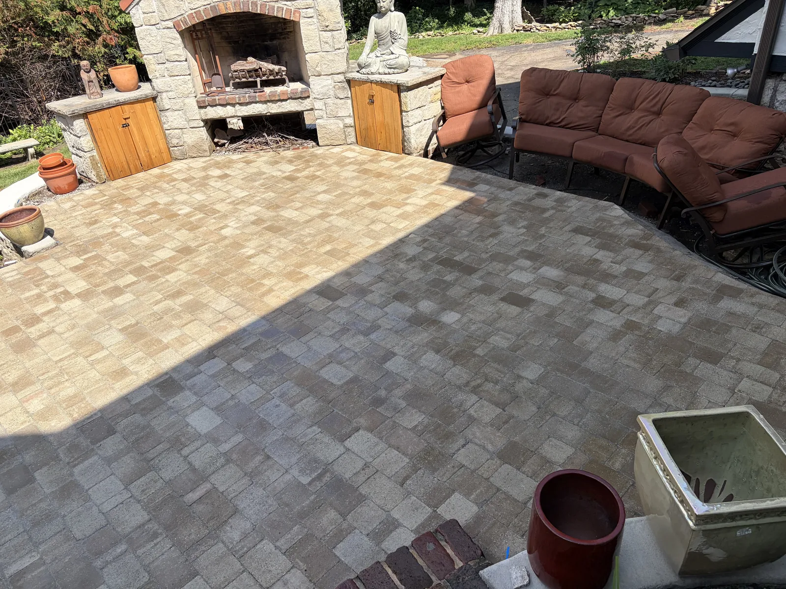 Stone fireplace and seating on a paver patio